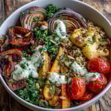 A hearty bowl of Roasted Vegetable Quinoa Bowl with caramelized veggies, fluffy quinoa, and fresh parsley garnish, ready for lunch.