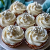 Elegant First Communion cupcakes featuring vanilla mini cupcakes with fondant rosary toppers and smooth buttercream frosting.  