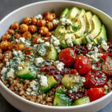 Colorful Ancient Grains Bowl with lemon tahini dressing and fresh veggies.