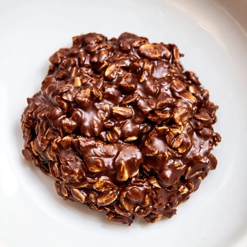 Close-up of freshly made No-Bake Chocolate Oatmeal Drop Cookies, chewy, with visible oats, ready to set.
