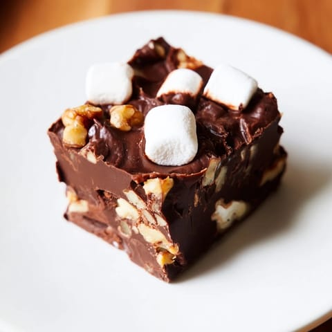 Creamy, decadent Rocky Road Fudge with fluffy marshmallows and crunchy nuts displayed beautifully.