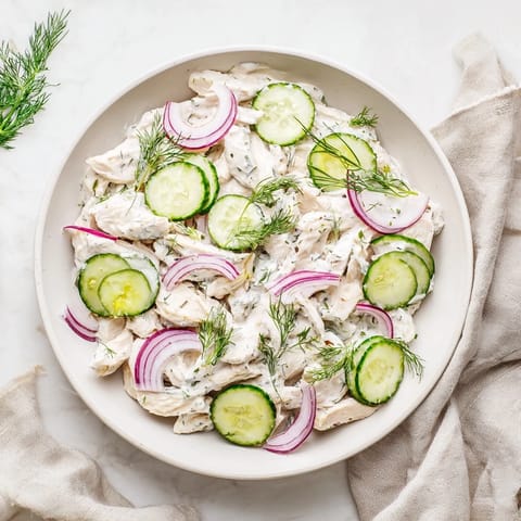 Creamy Cucumber Chicken Salad tossed with creamy yogurt dressing and red onions, ideal for a light, refreshing American-style lunch.