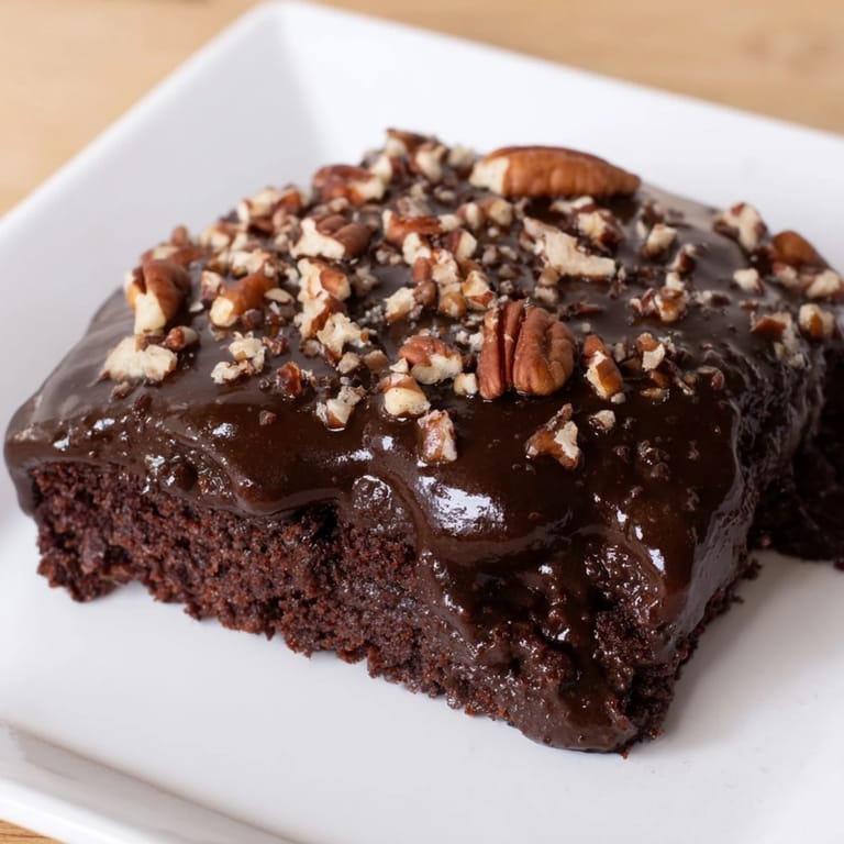 A perfect slice of Texas sheet cake, a moist chocolate cake with a sweet, creamy icing.