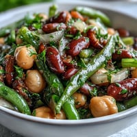 Vibrant Three-Bean Salad with tangy dressing, bursting with fresh garden flavors.