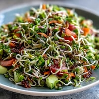 Vibrant Sprouted Seed Salad overflowing with fresh crisp vegetables and bright dressing.