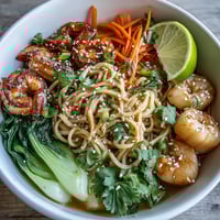 Vibrant Asian Noodle Bowl with Shrimp and Scallops, brimming with tender seafood, crisp vegetables, and silky noodles in savory broth.  